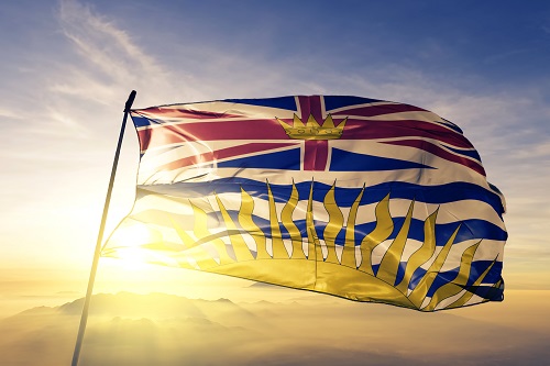 Displayed is the BC province flag with the sun setting behind it.